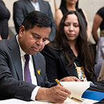 Minister Anandasangaree signing the official memorandum of understanding.