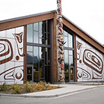 Building’s façade made of wood decorated with painting typical of Pacific Northwest Coast art.