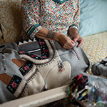 Leena decorating clothing with traditional Inuit beadwork and embroidery.