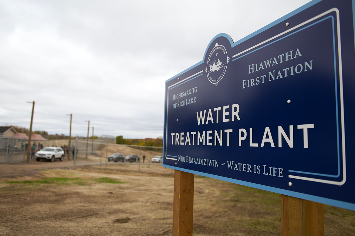 Road sign that says "Michisaagiig of Rice Lake, Hiawatha First Nation, Nibi Nimaadiziwin/Water Treatment Plant, Water is Life".
