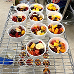 Fruit salad samples in small cups made during nutrition education classes.