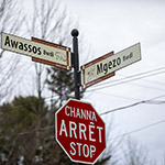 Stop sign and street name signs translated into Abenaki.