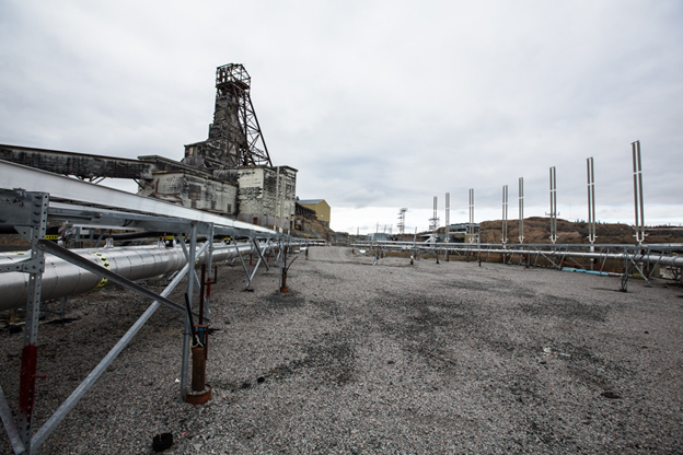 The Giant Mine headframe with, in the foreground, some of the pipes used for the frozen block method.